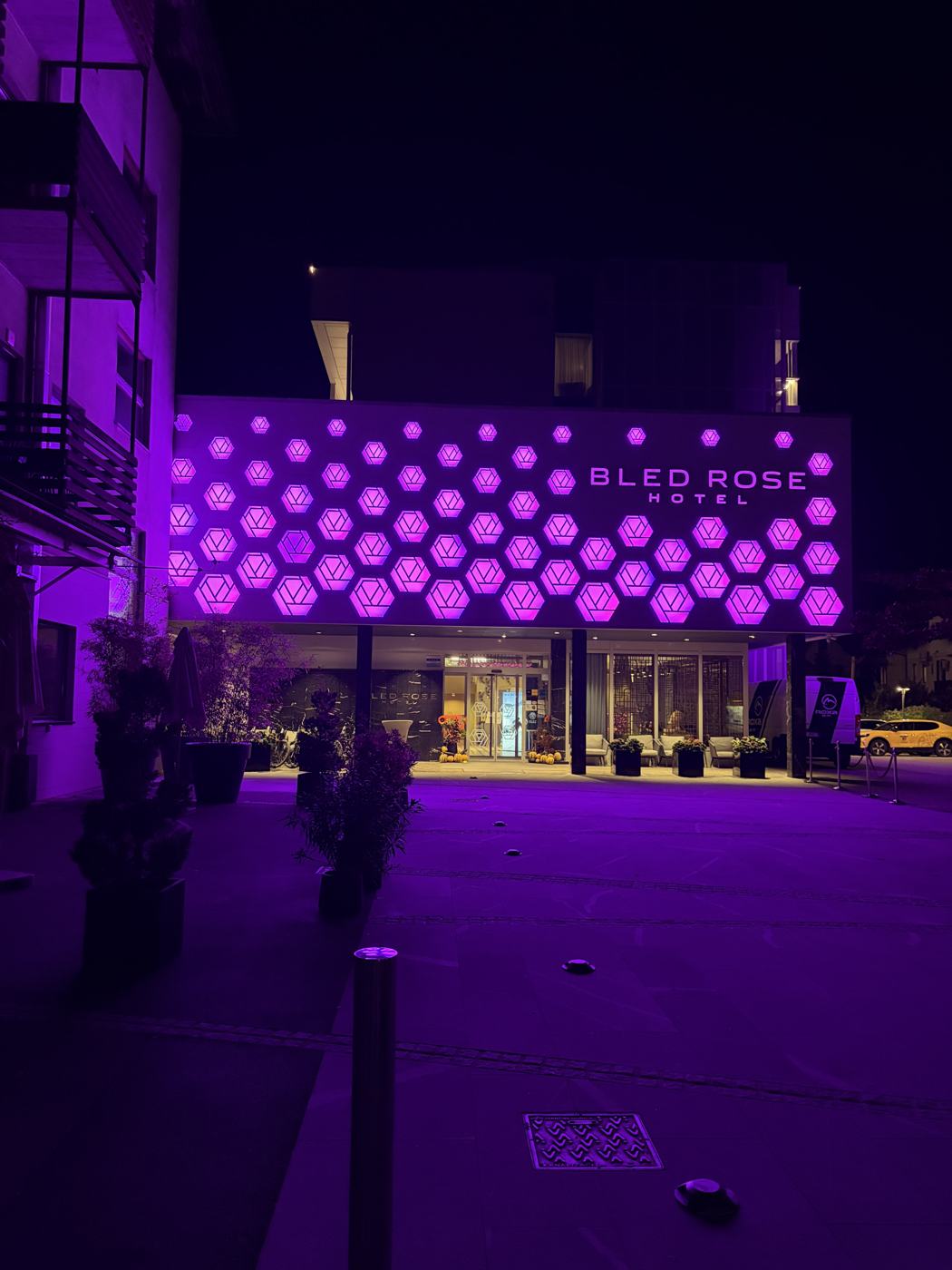 Bled Rose Hotel lit up purple at night