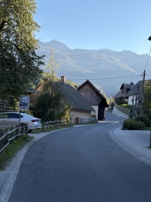 Village street in Stara Fužina with mountains behind