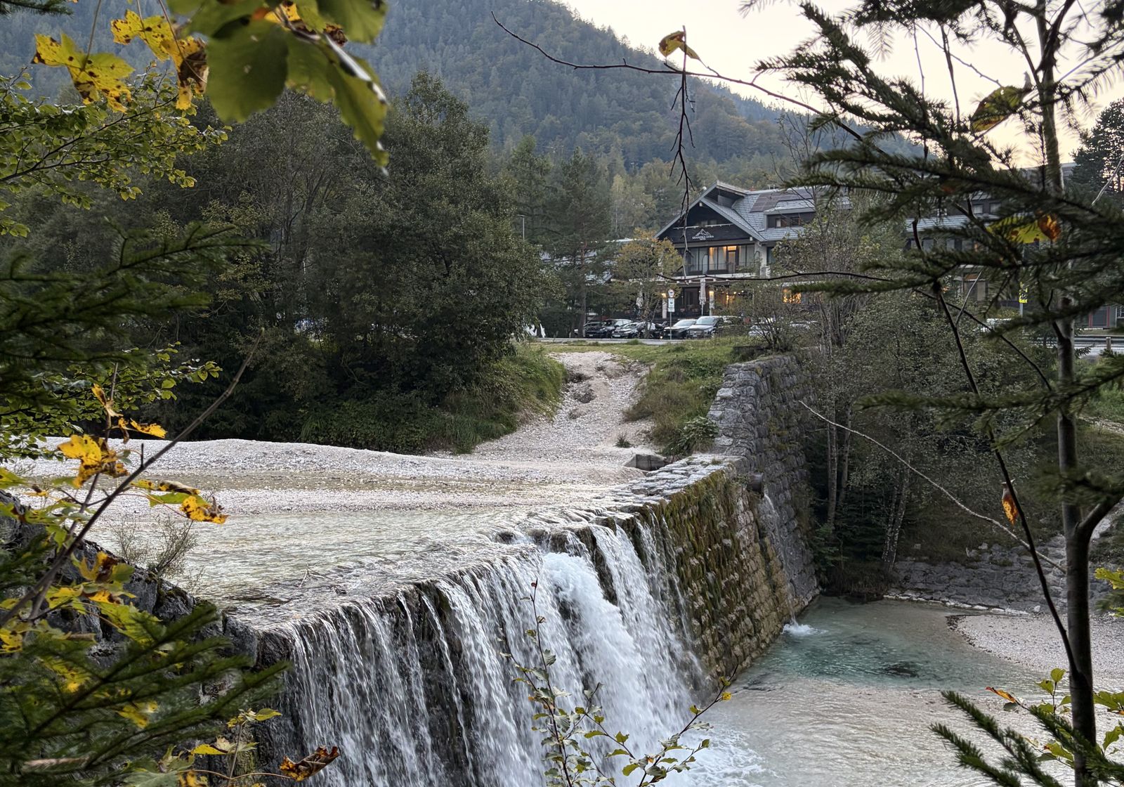 Hotel Kranjska Gora seen across the Pišnica stream and weir