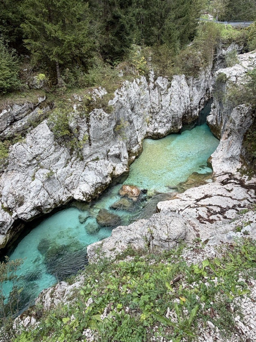 Emerald pool between white rock walls in the Great Soča Gorge