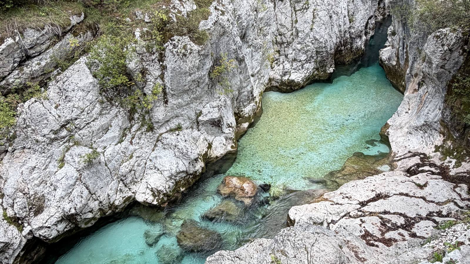 Emerald water between white limestone walls in the Great Soča Gorge